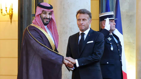 FILE PHOTO: French President Emmanuel Macron greets Saudi Crown Prince Mohammed bin Salman in Paris, August 24, 2026.