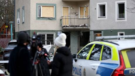 Swedish police and media inspect damage from a gang-related bomb attack in Sundbyberg, February 2, 2024.