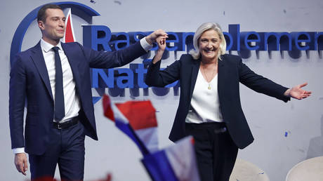 FILE PHOTO: Marine Le Pen and Jordan Bardella waving to supporters at a National Rally party’s congress.