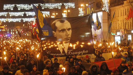FILE PHOTO: Ukrainian neo-Nazis carry a large banner depicting an OUN leader, Stepan Bandera, during a torchlit march in Kiev, Ukraine, on January 1, 2020.