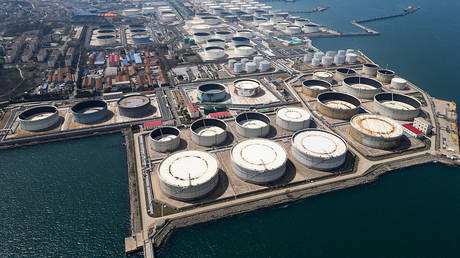 FILE PHOTO: an aerial view of crude oil storage tanks at a port terminal in Qingdao, China.