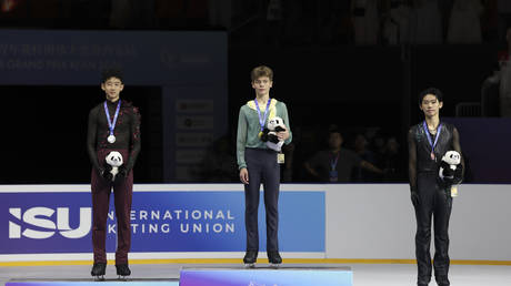 Silver medalist Yanhao Li, gold medalist Lev Lazarev and bronze medalist Daiya Ebihara (L-R) in Xi’an, China, on August 22, 2026.