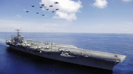The Nimitz Class Carrier USS Abraham Lincoln, and aircraft from Carrier Air Wing 2 perform an aerial demonstration in the South China Sea, on May 8, 2006.