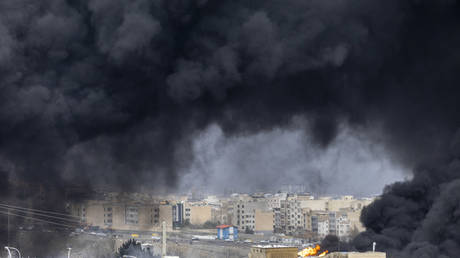 Smoke billows after airstrikes on oil depots on March 8, 2026 in Tehran, Iran