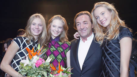 Former president of Elite Group Gerald Marie poses for pictures with models at the world final of the Elite Model Look 2005 competition in Shanghai, China, November 12, 2005.