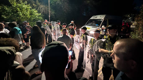 Police officers forming a line to block protesters near Eastney Beach in Portsmouth. England.