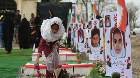 FILE PHOTO. Iranians gather at a cemetery to commemorate victims, most of them children, killed in a US Israeli attack on a primary school in Minab, Iran on March 20, 2026.