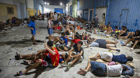 FILE PHOTO: Dozens of migrants spend the night on the streets after swimming from Morocco to Ceuta, Spain, 31 July, 2026.