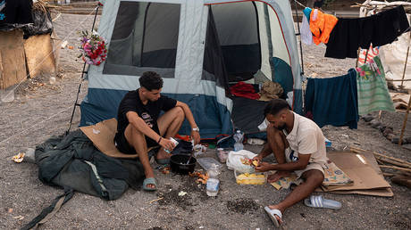 Migrants are seen in an improvised shanty camp in El Trampolin Beach on August 14, 2026 in Ceuta, Spain.