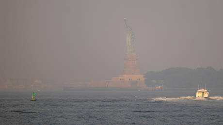 Haze from Canadian wildfires obscures the Statue of Liberty in New York City, July 17, 2026.