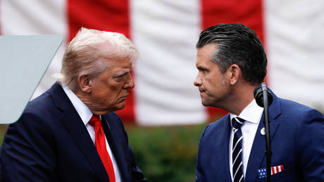 FILE PHOTO: US President Donald Trump (L) and US Secretary of War Pete Hegseth (R).