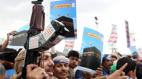 Houthi supporters brandish weapons during a demonstration in Sanaa, Yemen, on September 18, 2026.