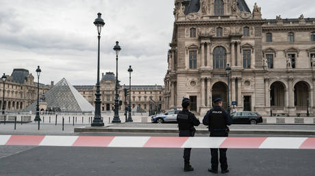 French police officers stand in front of the Louvre Museum after a robbery in Paris, France, on October 19, 2025.