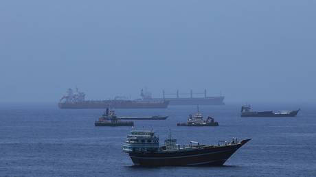 Commercial cargo vessels and oil tankers anchor in the Gulf of Oman on June 21, 2026.