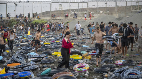 Migrants cross the border between Ceuta and Morocco on July 31, 2026 in Ceuta, Spain
