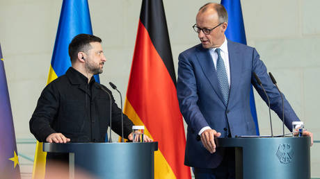 FILE PHOTO: German Chancellor Friedrich Merz (R) and Ukraine's Vladimir Zelensky (L) hold a press conference in Berlin, Germany, on April 14, 2026.
