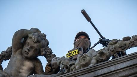 A police sniper watches the sky above Amalienborg Palace in Copenhagen, Denmark, October 1, 2025