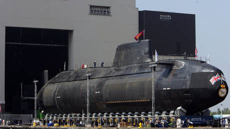 Royal Navy submarine HMS Astute emerges from its berth at the BAES shipyard on June 8, 2007, in Barrow-in-Furness, United Kingdom.
