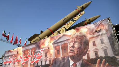 FILE PHOTO: A banner depicting US President Donald Trump being displayed in front of Iranian ballistic missiles exhibited in central Tehran.