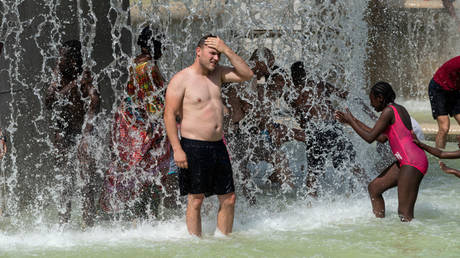 A man bathes in the Trocadero fountain amid a heatwave in Paris, France, July 25, 2019