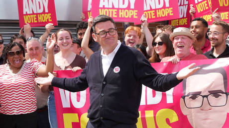 Andy Burnham greets supporters at the Labour Party campaign HQ in Ashton-in-Makerfield, England, June 18, 2026