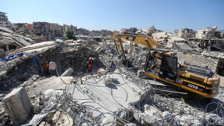 Palestinian civil defense teams clear the rubble in Gaza City, Gaza, on August 6, 2026.