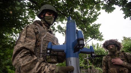 Ukrainian soldiers hold an interceptor drone near the front line on the outskirts of Sumy, Ukraine, June 13, 2026.