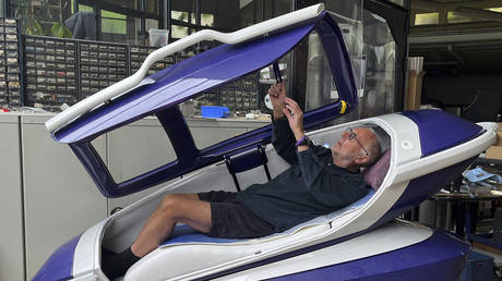 FILE PHOTO. Philip Nitschke enters a 'suicide pod' known as 'The Sarco' in Rotterdam, The Netherlands.