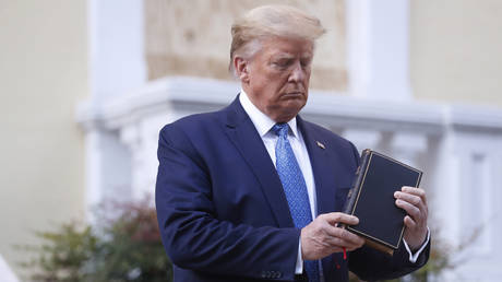 FILE PHOTO: US President Donald Trump poses with a bible.