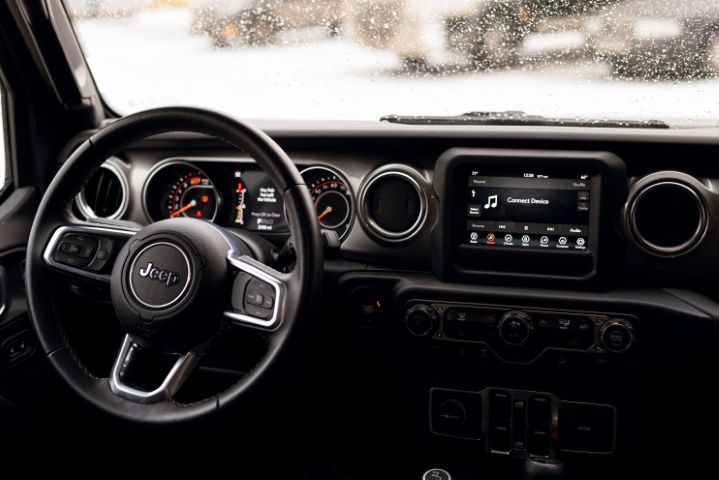 Jeep factory radio and dashboard before a custom audio upgrade