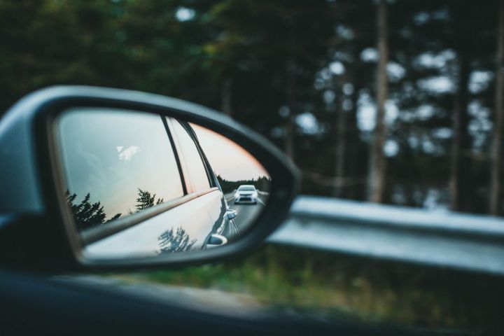 Vehicle visible in a driver's side mirror after a collision