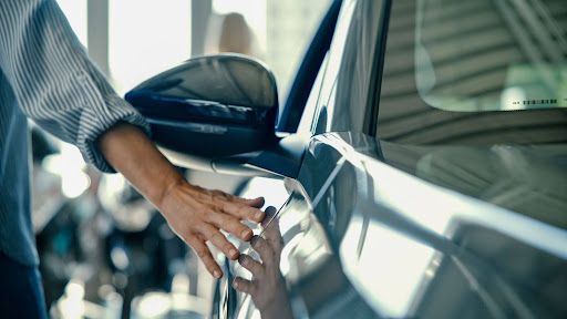 Professional installer applying paint protection film to a vehicle