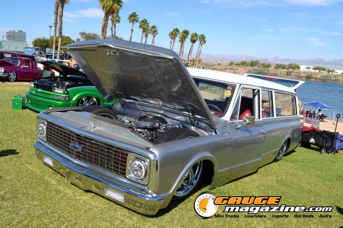 Slammed silver Chevrolet Suburban with detailed engine bay at Forbidden Fantasy Show n Shine 2026