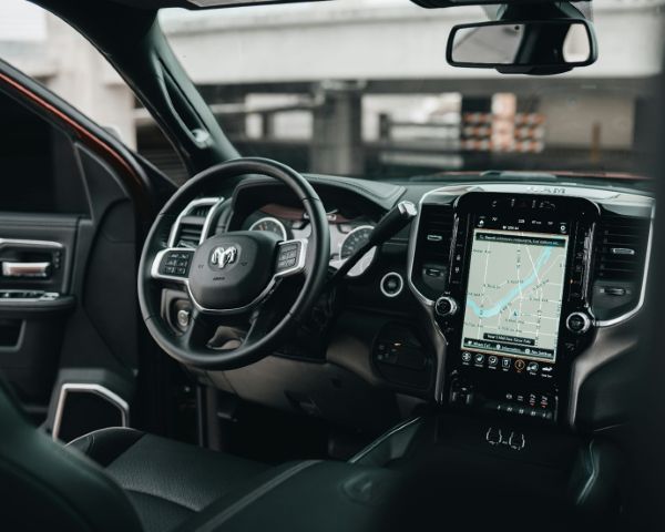 Ram truck interior with steering wheel and vertical infotainment screen