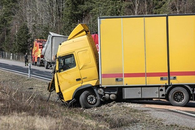 Yellow semi-truck involved in a roadside accident