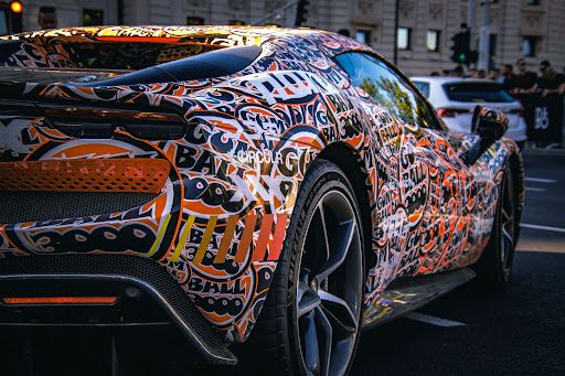 Custom vehicle finish illustrating the choice between vinyl wrap and paint