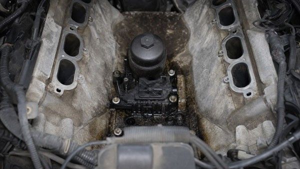 Pentastar oil cooler and filter housing beneath the intake manifold