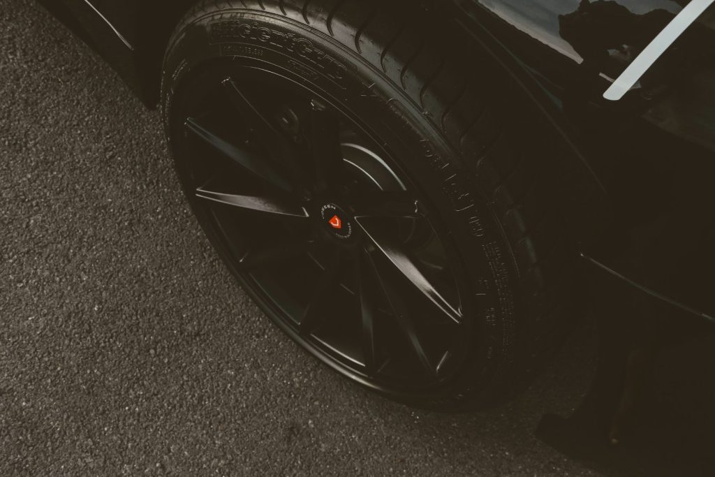 Black aftermarket wheel fitted with a low-profile tire