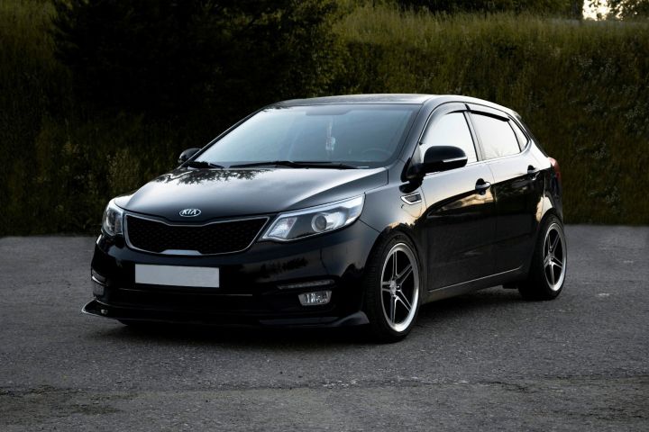 Black Kia passenger car parked outdoors