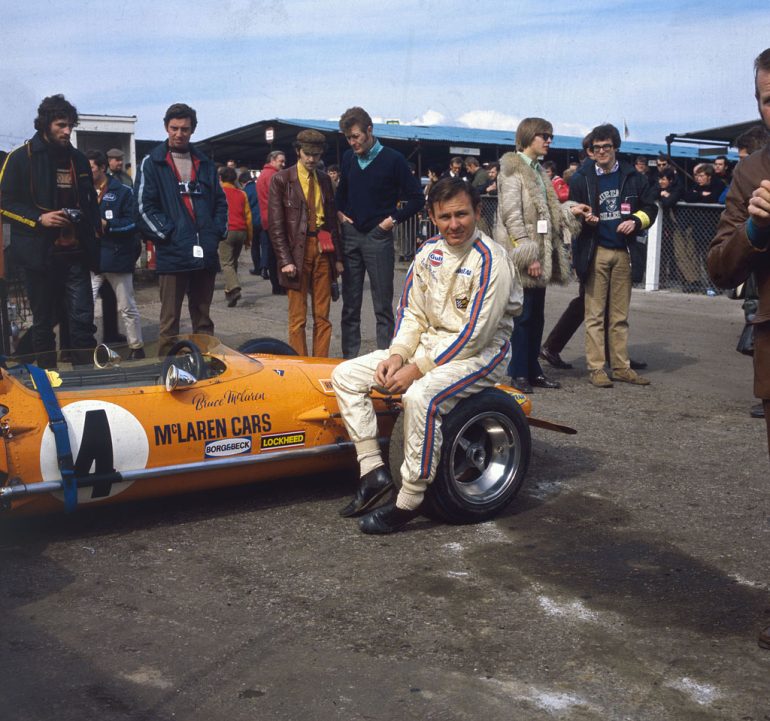 March 1970: New Zealand motor-racing driver Bruce McLaren (1937 - 1970) sits on the wheel of his McLaren-Ford M14A before the start of the Race of Champions at Brands Hatch in Kent. (Photo by Fox Photos/Getty Images)