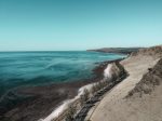 A car driving on an open coastal highway in Australia